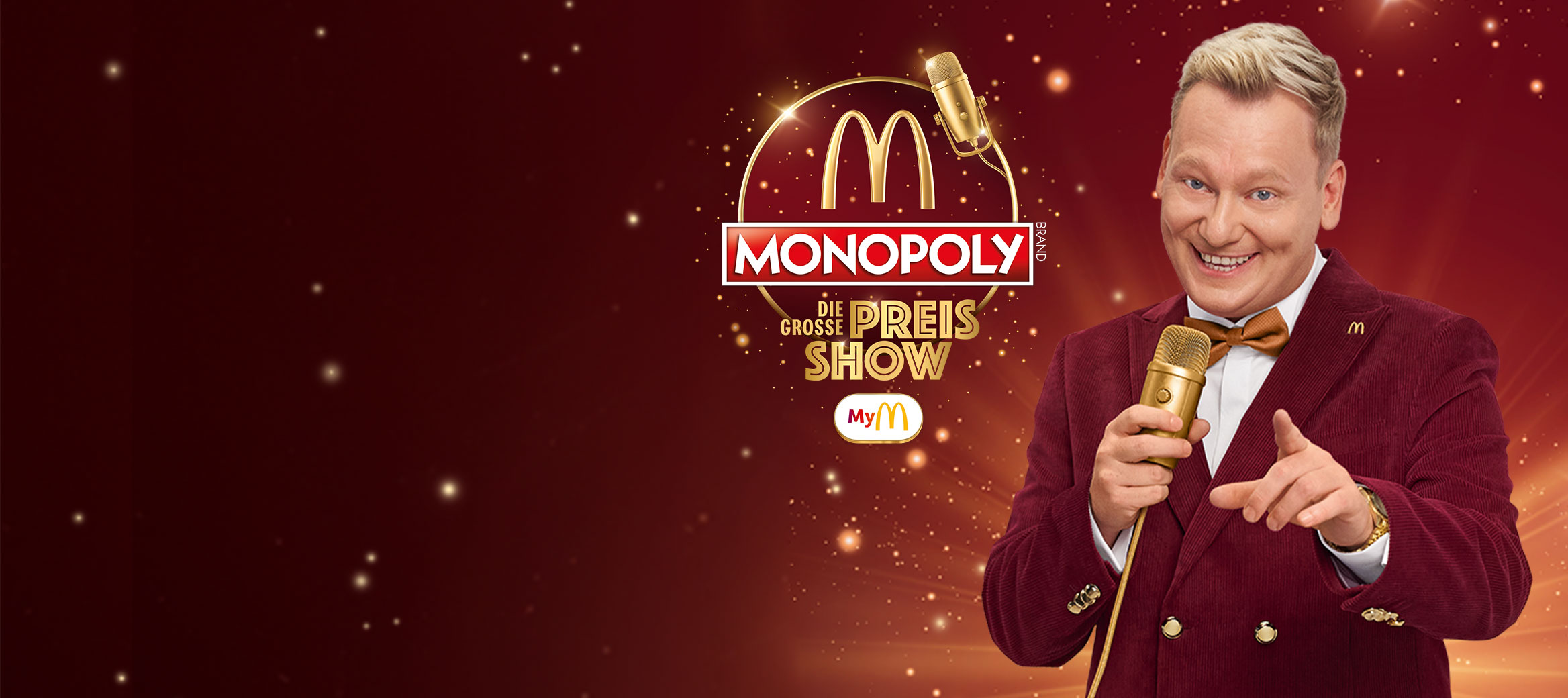 Wir sehen das MONOPOLY Logo „Die große Preis-Show“ Knossi mit einem goldenen Mikrofon in der Hand.