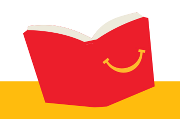 Open Happy Meal book with a smile on a yellow shelf