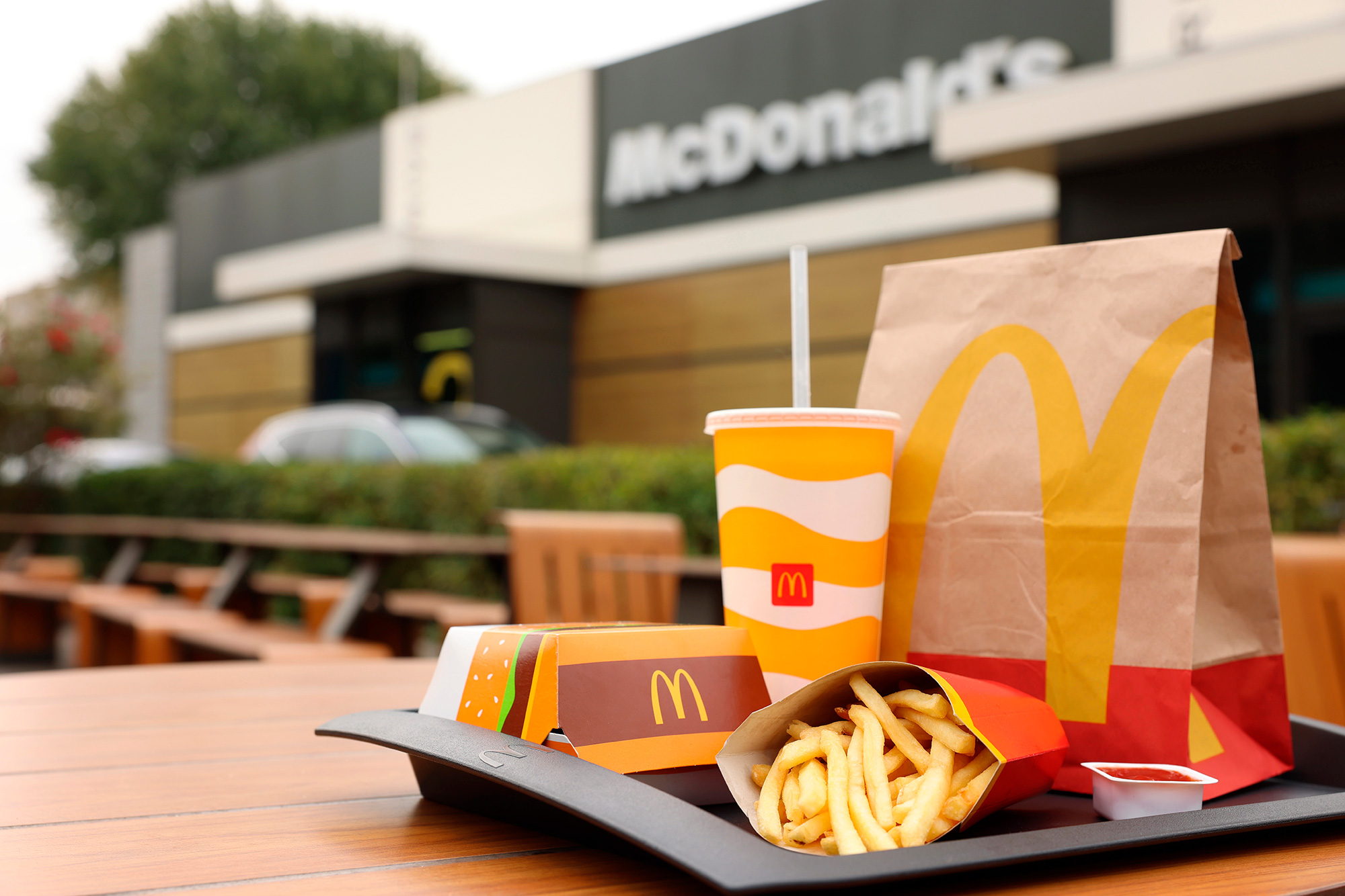 Lviv, Ukraine - October 9, 2023: McDonald's menu on wooden table outdoors, space for text