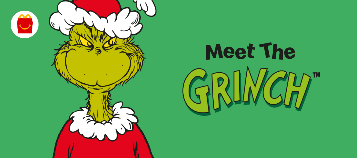 The Grinch wearing a Christmas hat with a smile and a green background