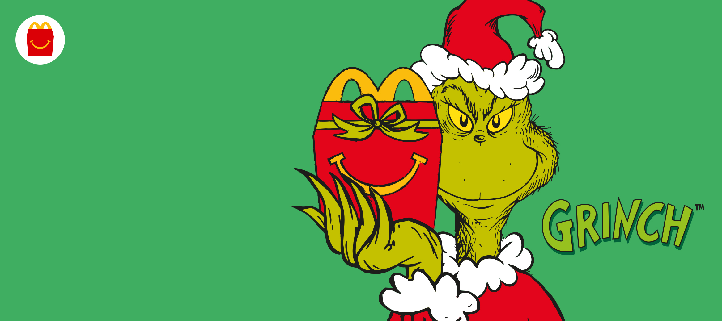 The Grinch wearing a Christmas hat holding a red Happy Meal box with a smile and a green bow