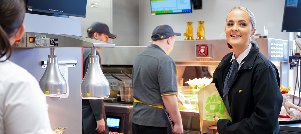 McDonald’s staff smiling whilst working.