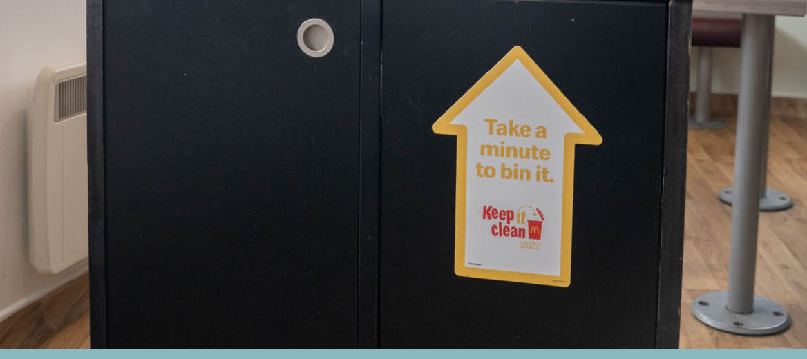 Recycling point in McDonald's restaurant reading 'Take a minute to bin it' and 'Keep it Clean'