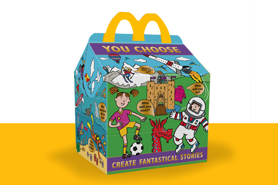 Happy Meal box with You Choose characters on a sky blue background, on green grass, on a yellow shelf